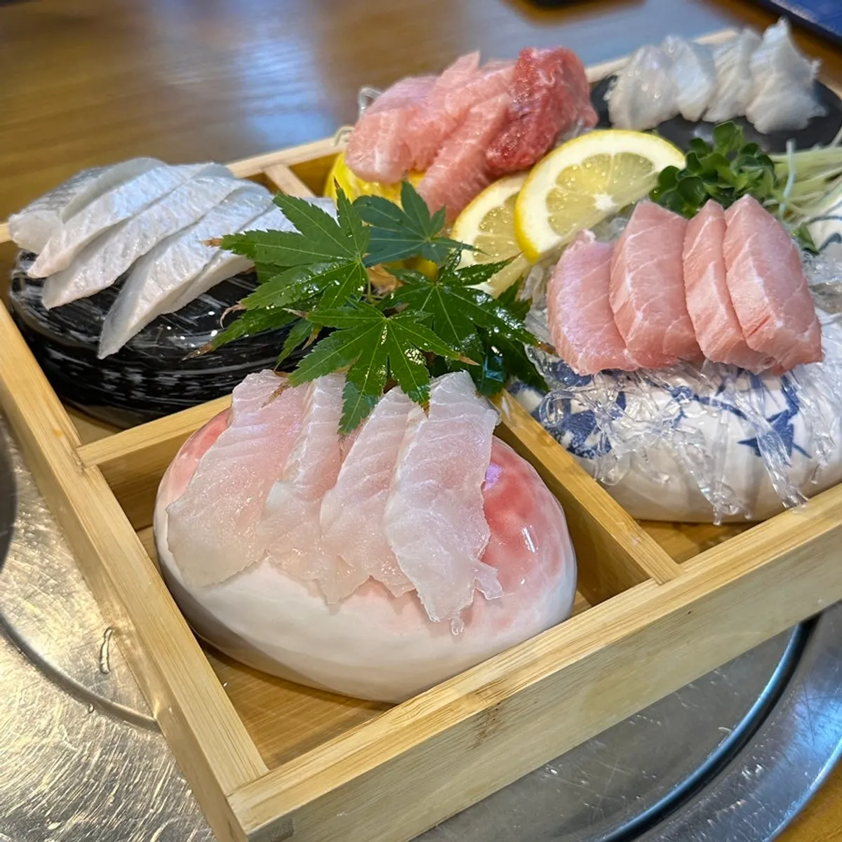 Assorted sashimi platter served in a wooden bowl
