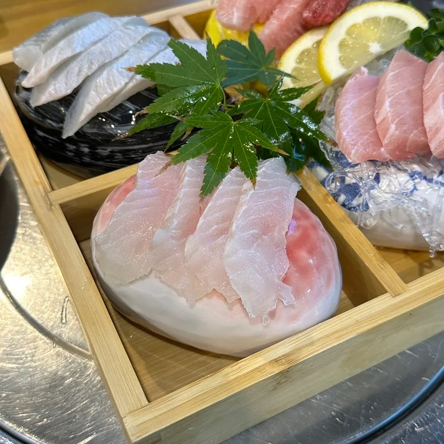 Sashimi plating topped with a maple leaf garnish