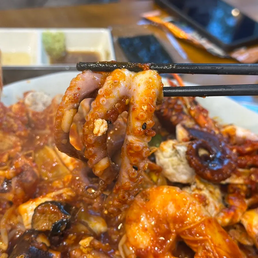 Whole shrimp with head intact inside the seafood stew
