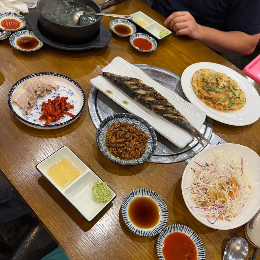 A spread of banchan including bossam and beondegi