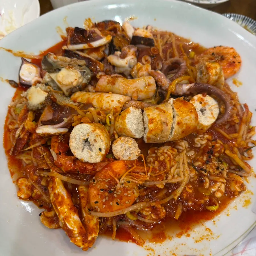 A seafood stew plate with abalone and other seafood