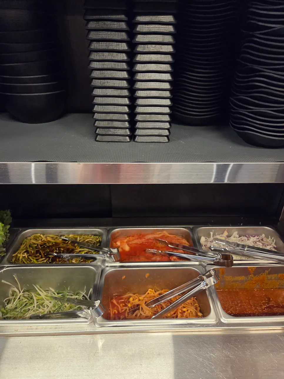 Self-serve bar with side dishes and sauces
