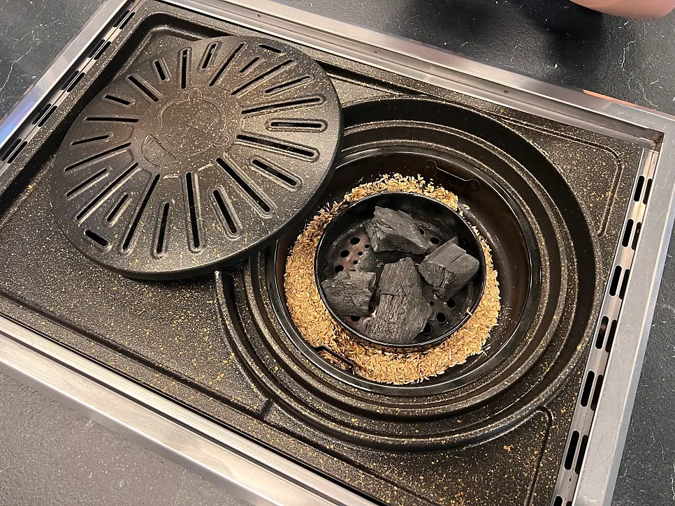 Domestic rice husks placed beside charcoal