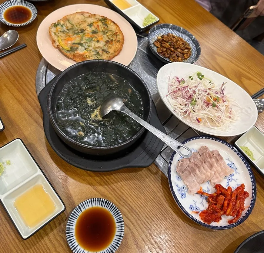 Full table of side dishes served with the assorted sashimi
