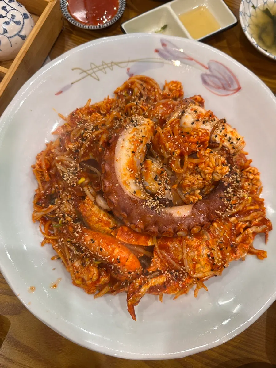 Braised seafood topped with whole octopus