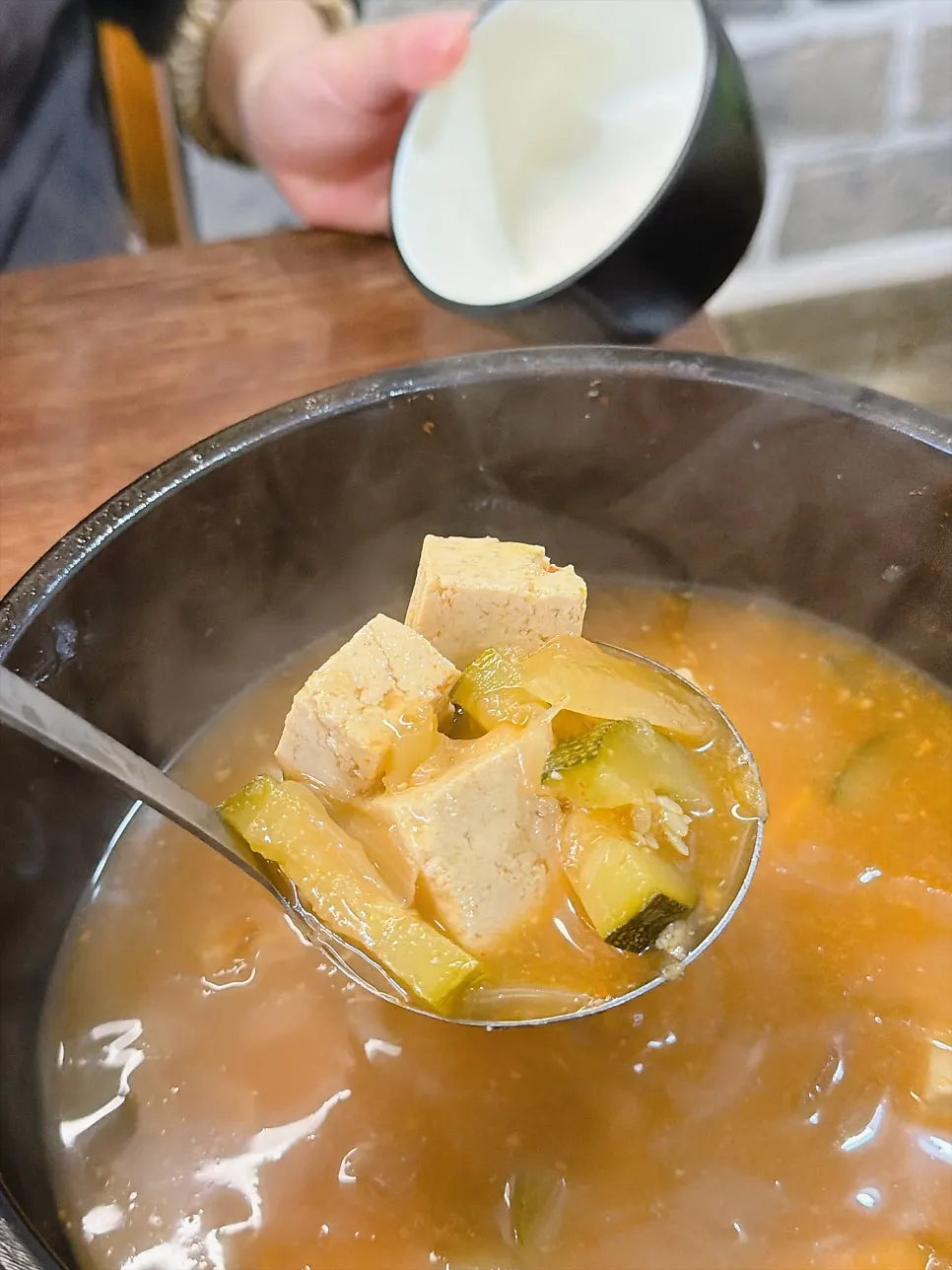 Pot of doenjang jjigae and side dishes
