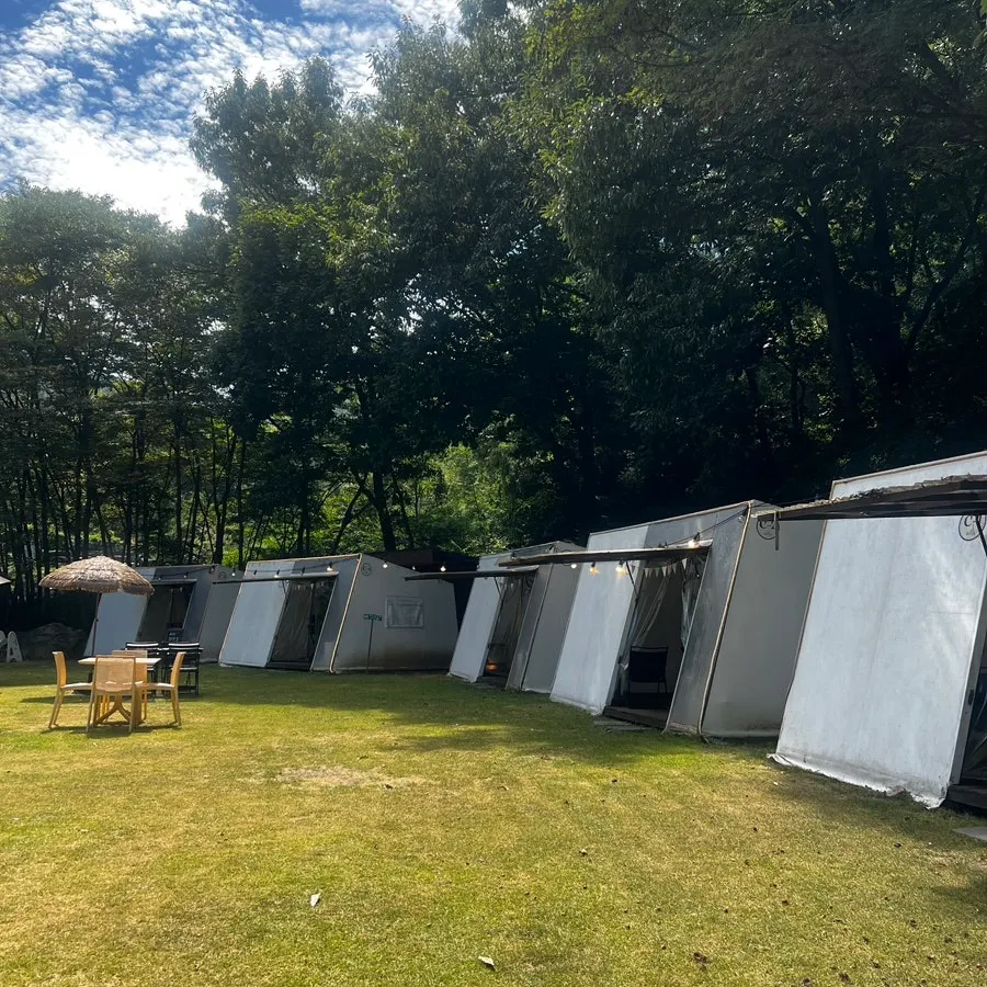 Lawn and outdoor tent zone at Pino Cafe