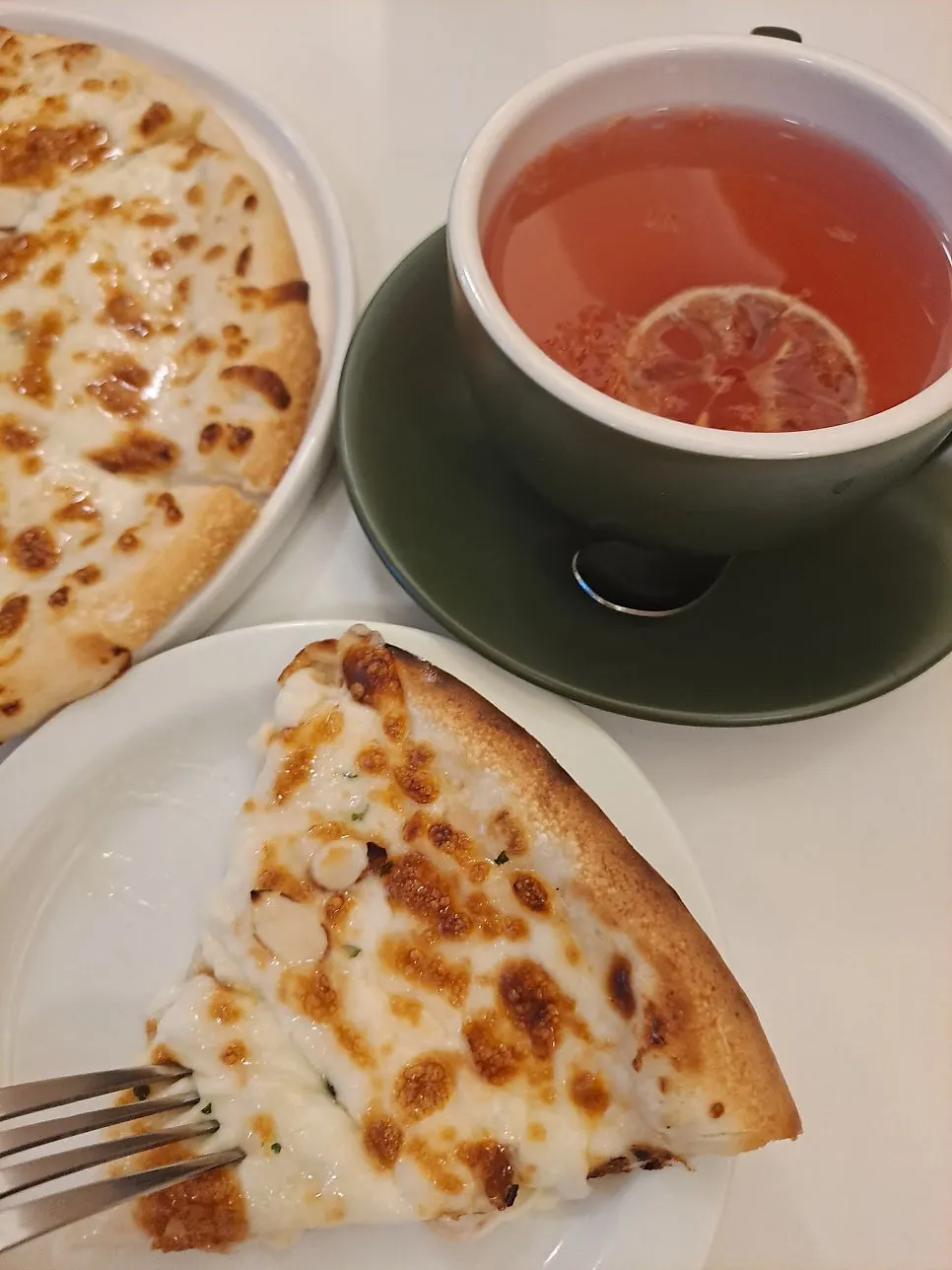 Cheese stretching from a slice of Siyudang pizza