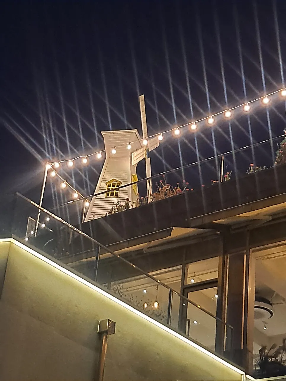 Night view of Siyudang's rooftop windmill seen from a distance