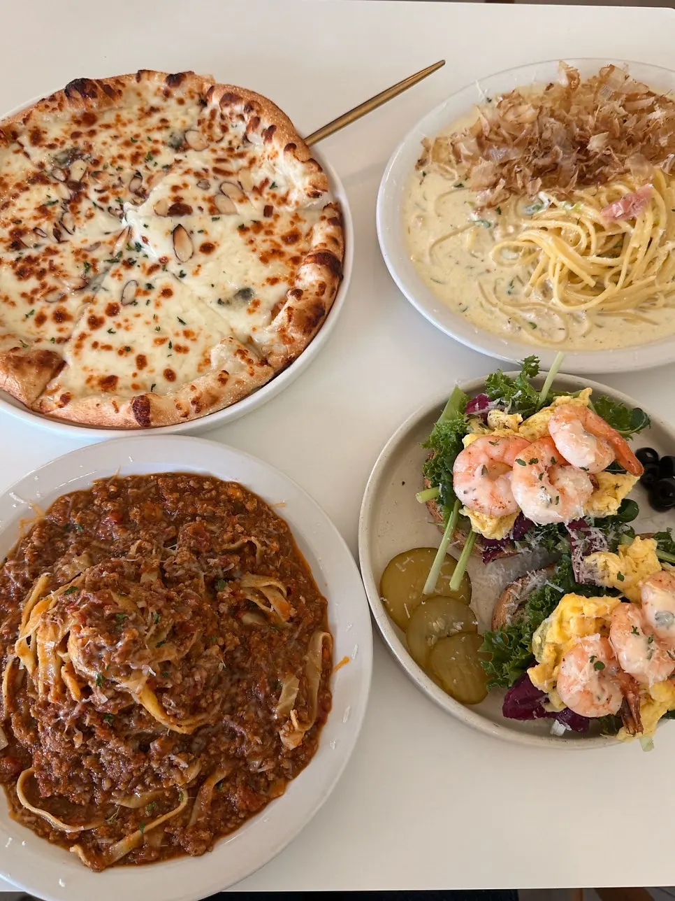 Table set with pasta, pizza and sandwich