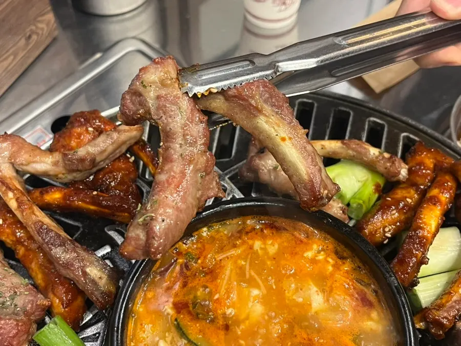 Par-grilled pork ribs and green onion on the grill