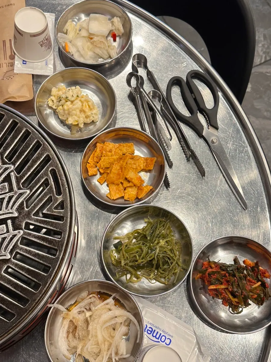 Table of basic side dishes including seaweed stem and green onion kimchi