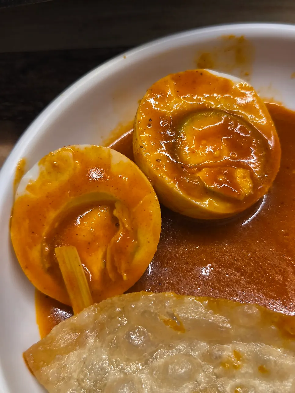 Flat mandu being dipped into the broth