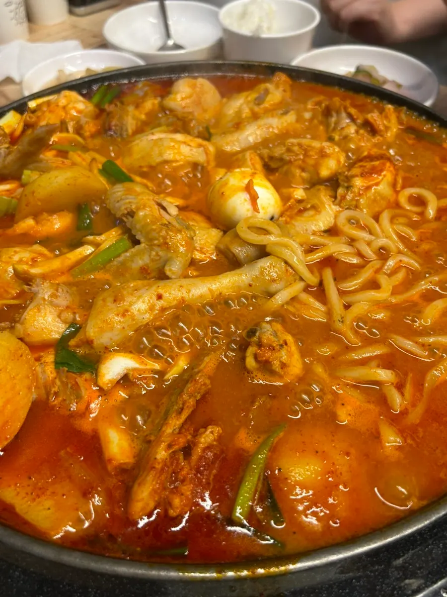 Udon noodles cooking in the sauce