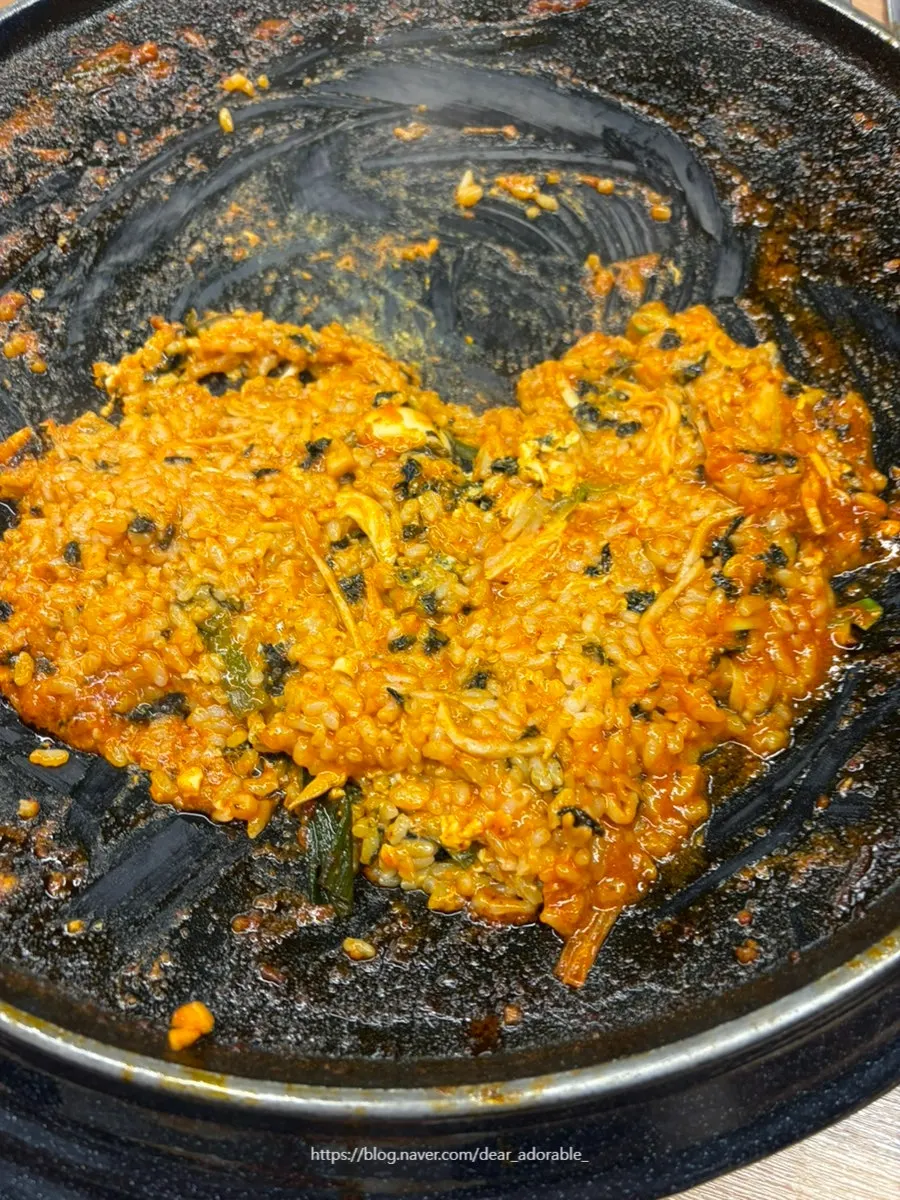 Rice being fried in the leftover sauce