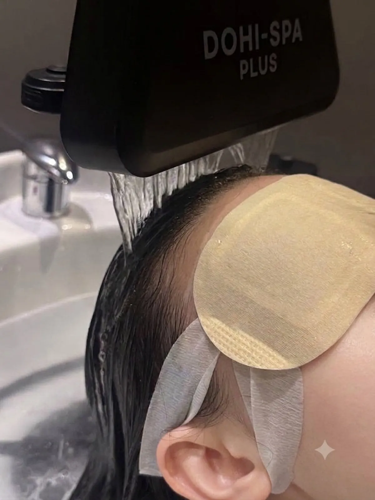 Scalp spa treatment with a warm eye mask on