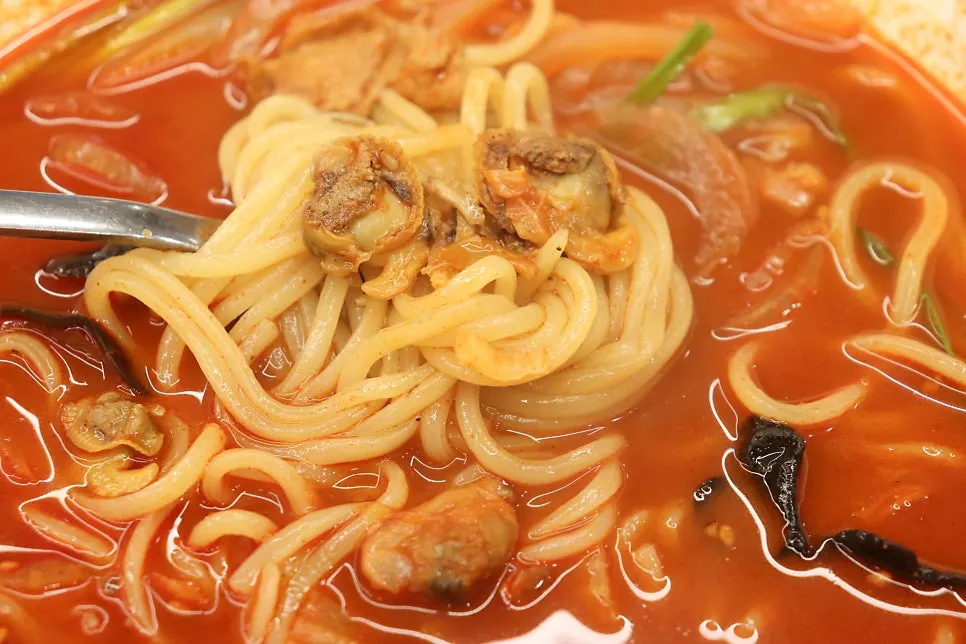 Sweet and sour pork dunked in sauce