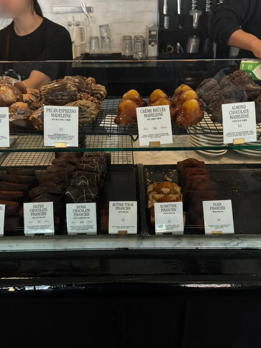 Canelés and flan on the dessert display shelf