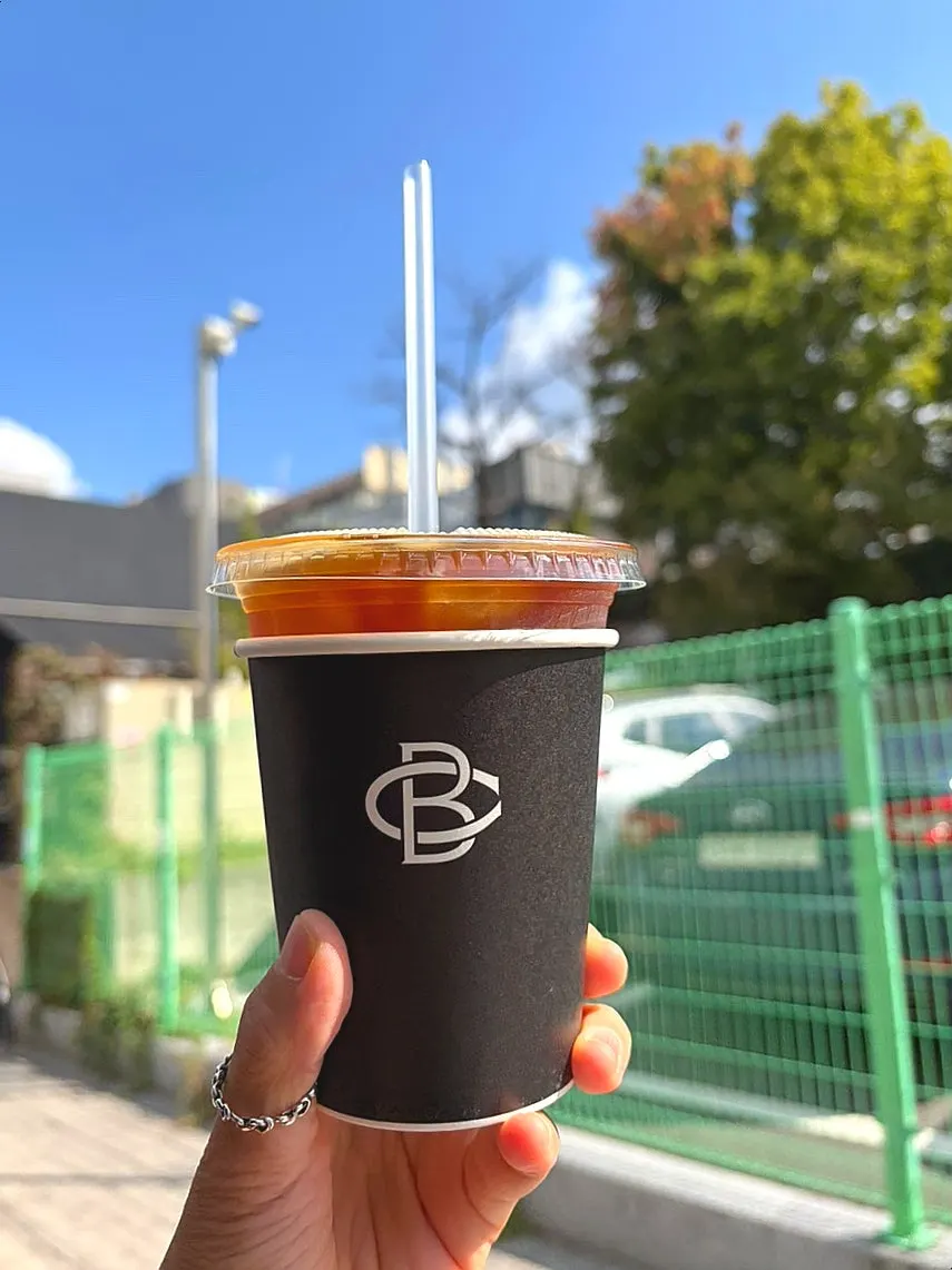 Iced americano in a Brewers Coffee logo cup
