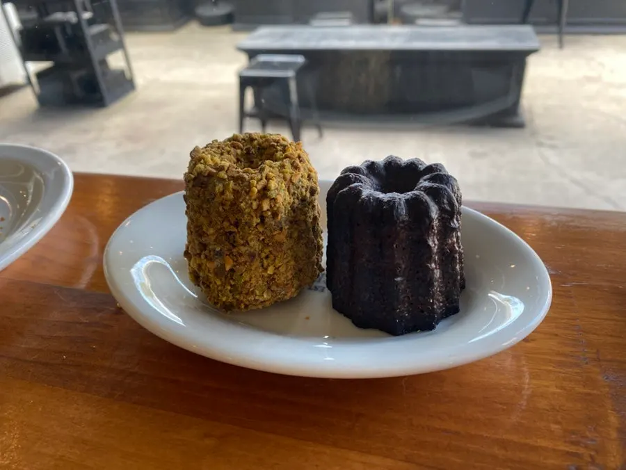 Pistachio canelé covered generously with pistachio