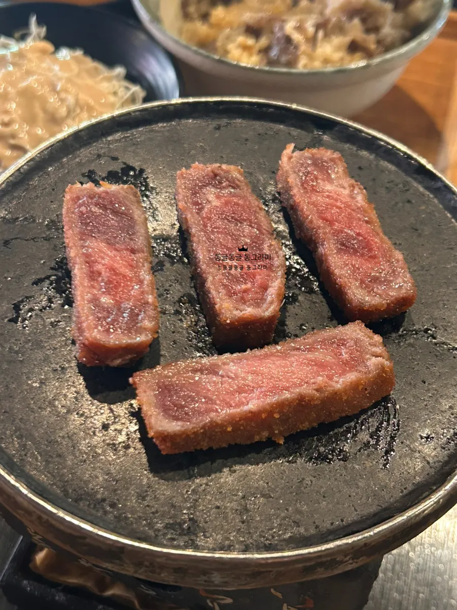 Cross-section of gyukatsu dipped in sauce