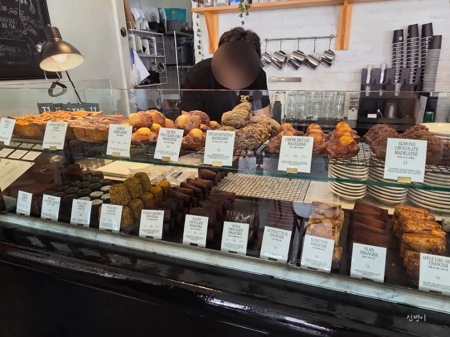 Fully stocked display case of baked goods at Brewers Coffee