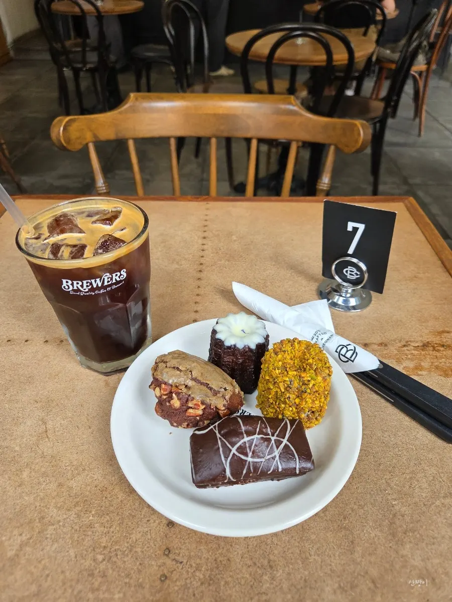 Solo table of baked goods and iced americano