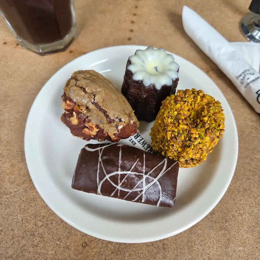 Plate of desserts next to iced americano