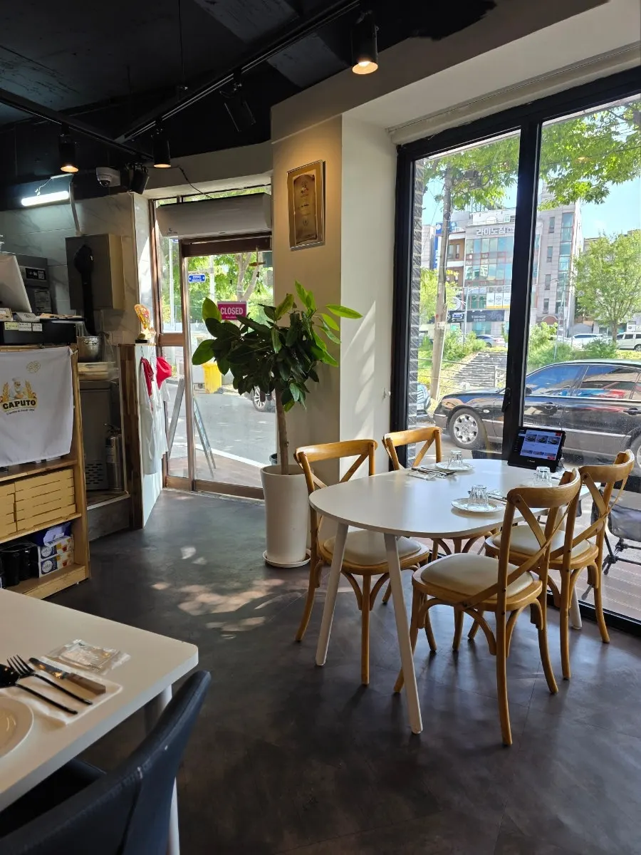 Seating with a floor-to-ceiling window view at Napoli Shinbu