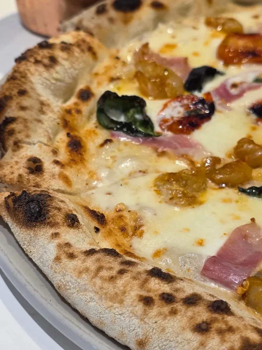 Guanciale pizza partway through being eaten