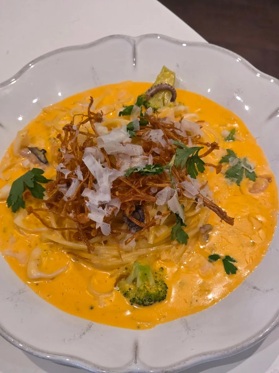 Pasta noodles coated in rosé sauce