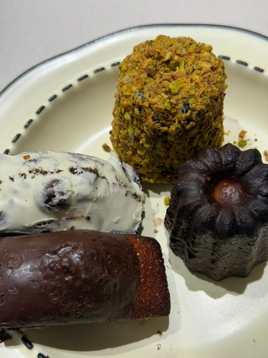 Coffee served with financiers and canelés