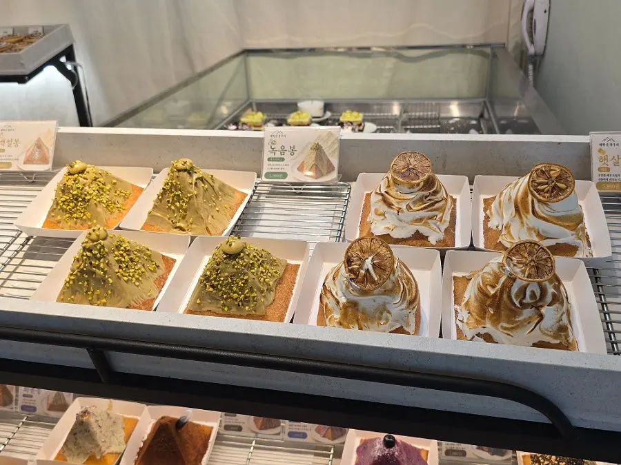 Display case with mountain-shaped breads by variety