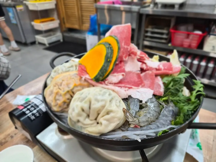 Dumpling hot pot with napa cabbage and crown daisy