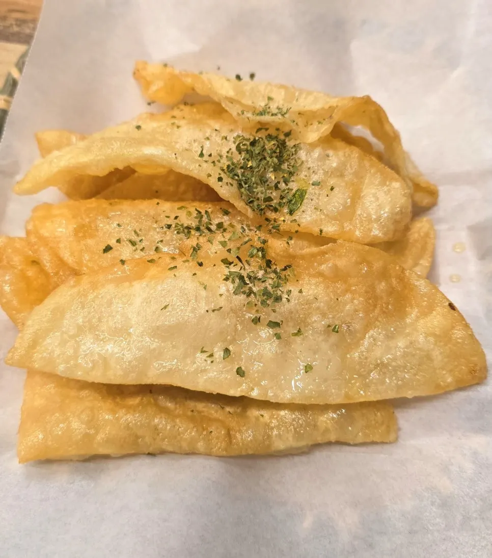 A plate of crispy, sliced grilled flat mandu