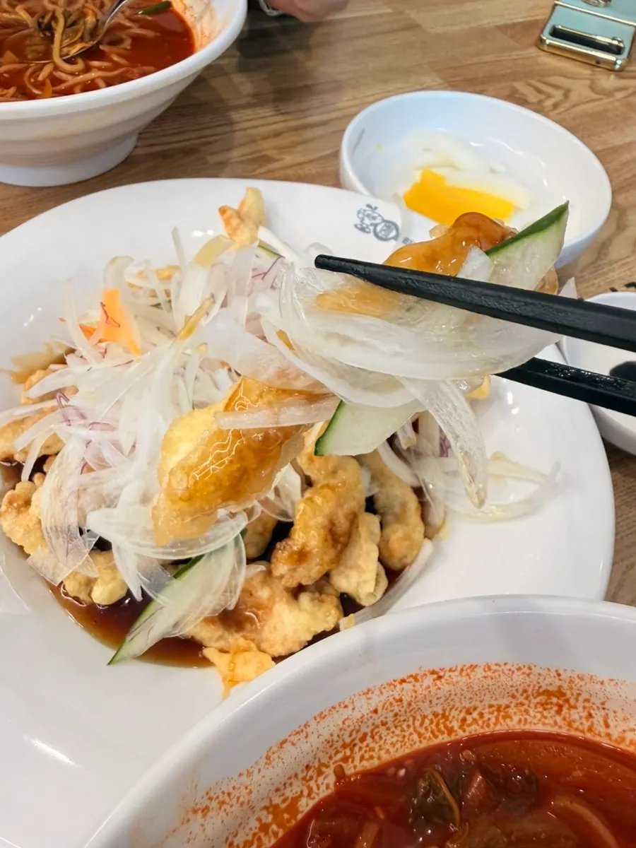 Table set with cockle jjamppong and sweet-and-sour pork