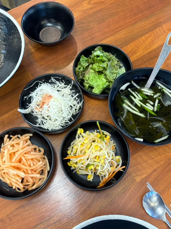 Table spread of octopus stir-fry, stone pot rice, and fried shrimp set