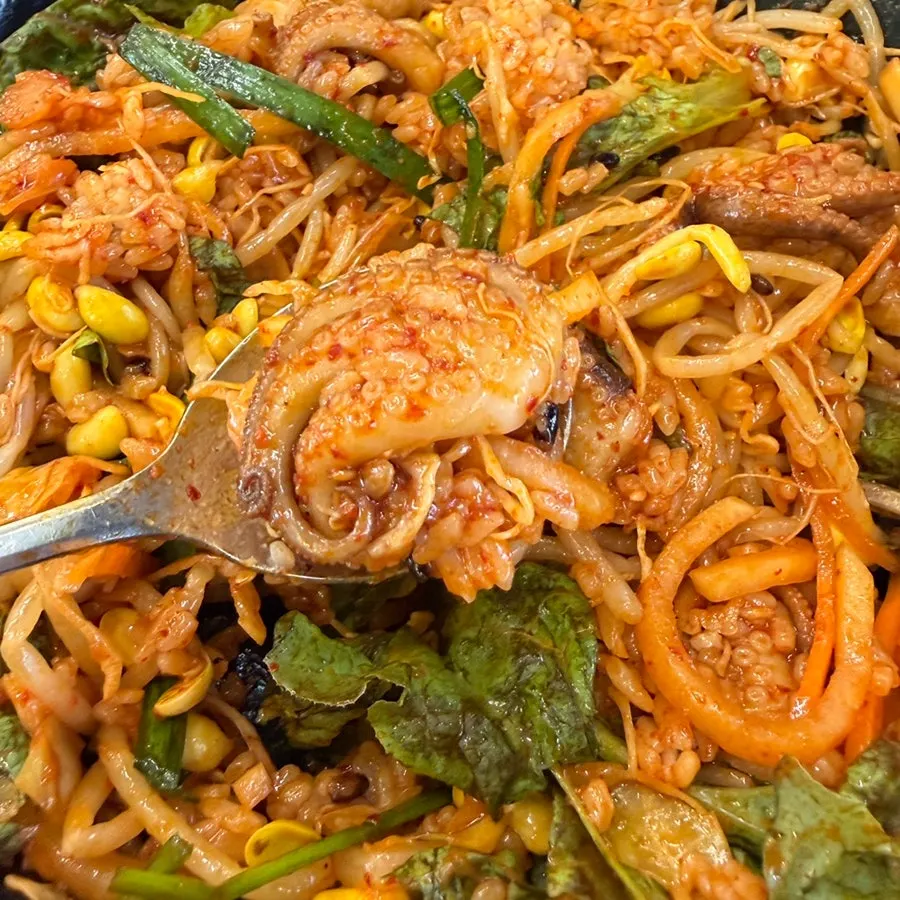 Close-up of smoky, charred octopus stir-fry