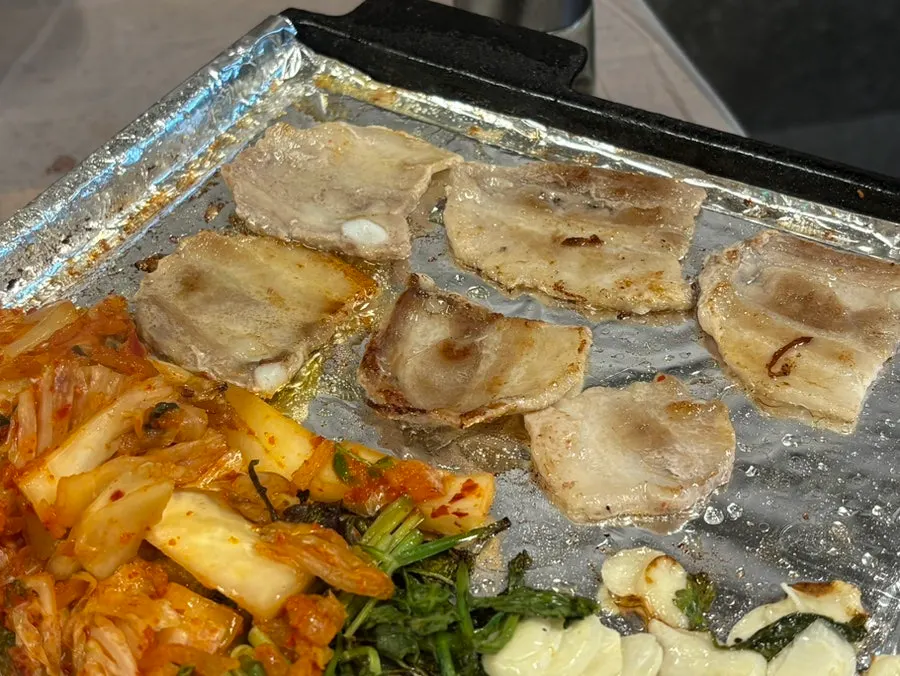 Pork belly cooking to a golden brown