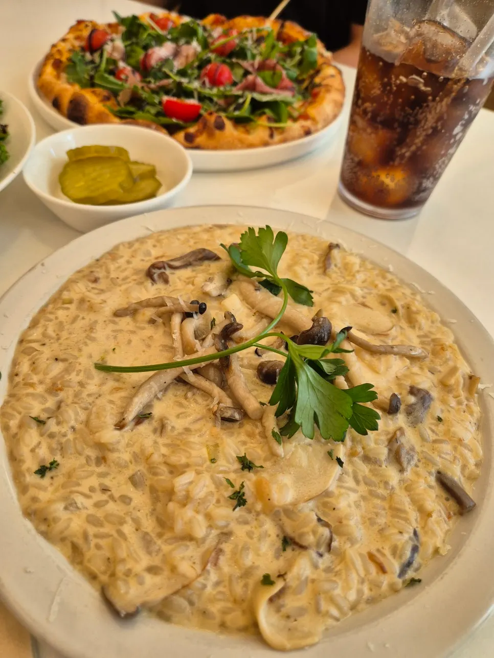 Brunch table setting with risotto, pizza, and salad