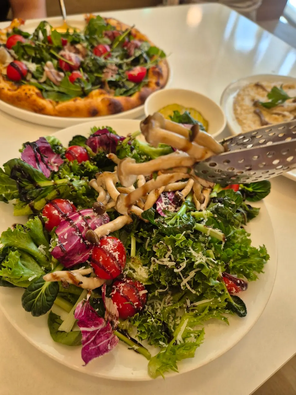 Arugula prosciutto pizza and porcini mushroom salad