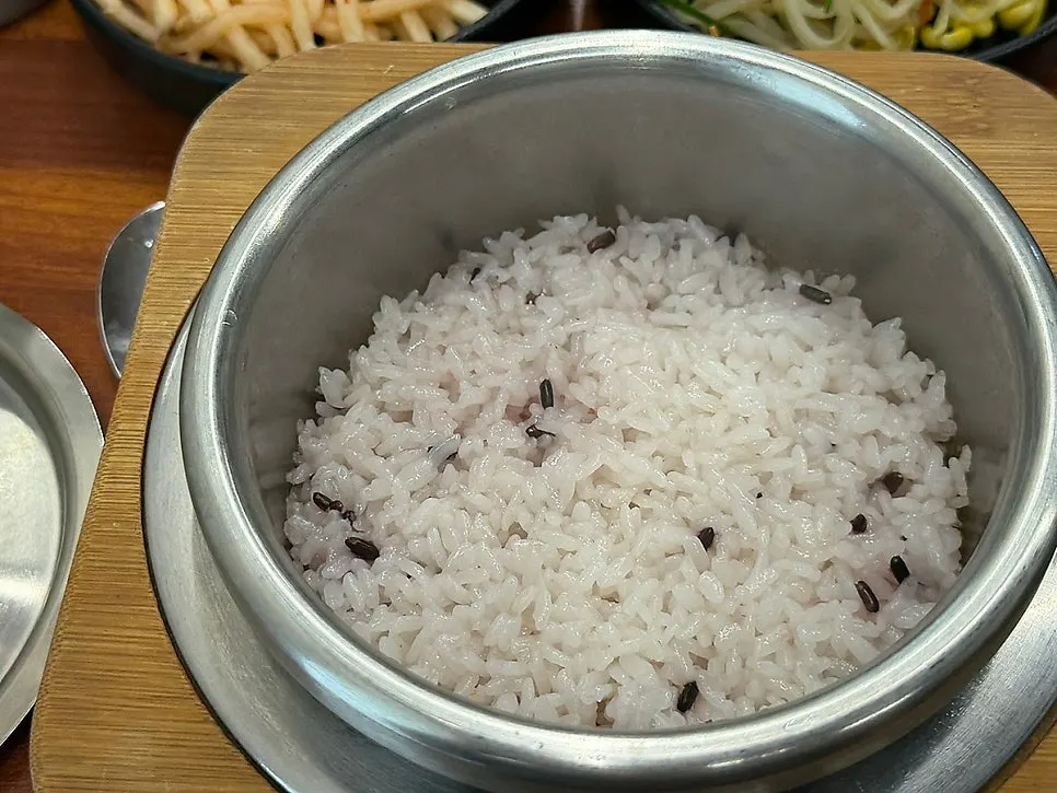 Table setting with freshly cooked hot pot rice and jjukkumi stir-fry