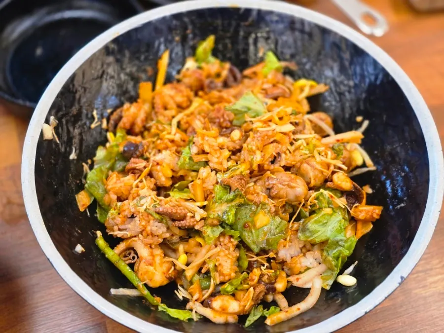 Bowl with rice and side dishes ready for mixing
