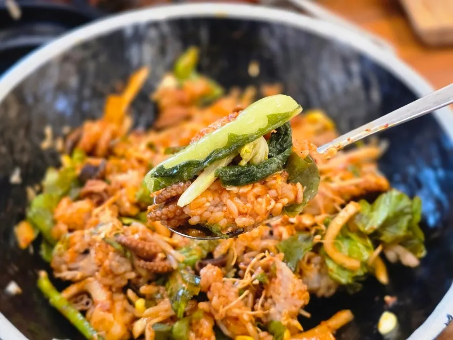 A spoonful of mixed octopus rice