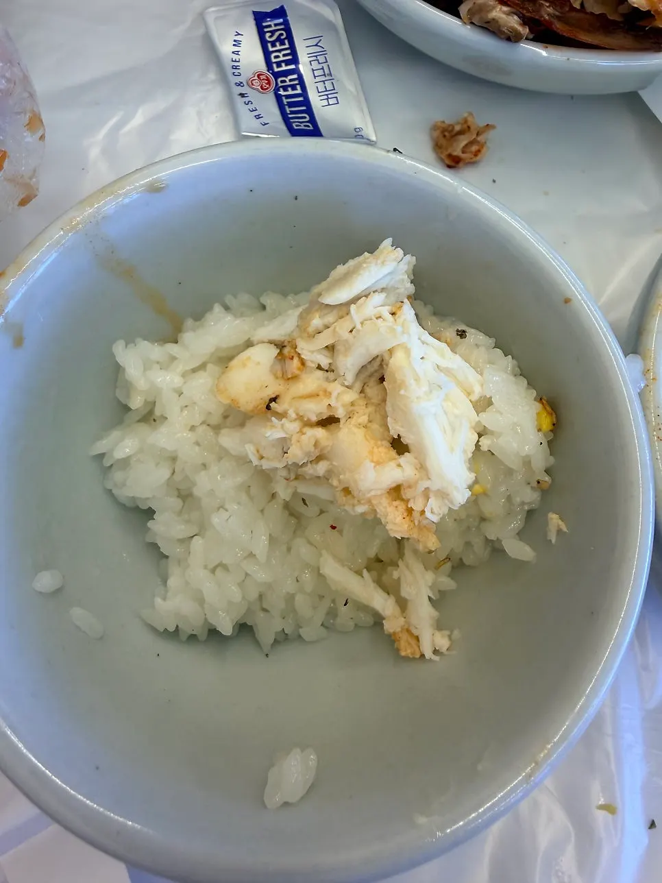 Picked crab meat next to the crab soup broth