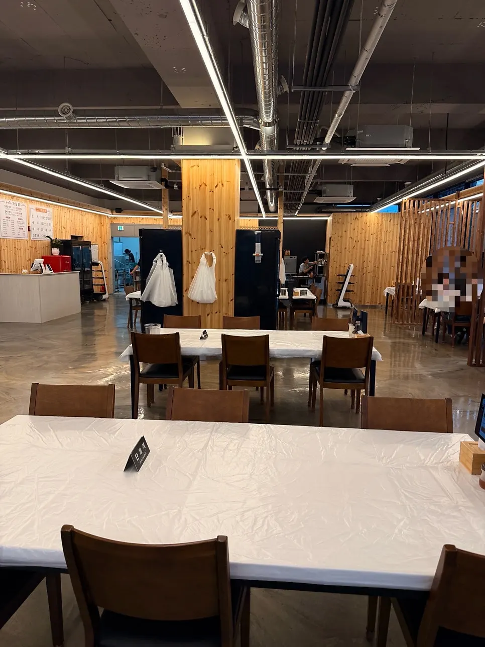A spacious dining hall with a baby chair set up