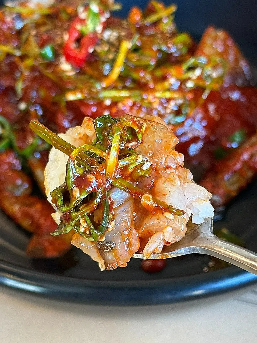 Meal of spicy marinated crab with minari