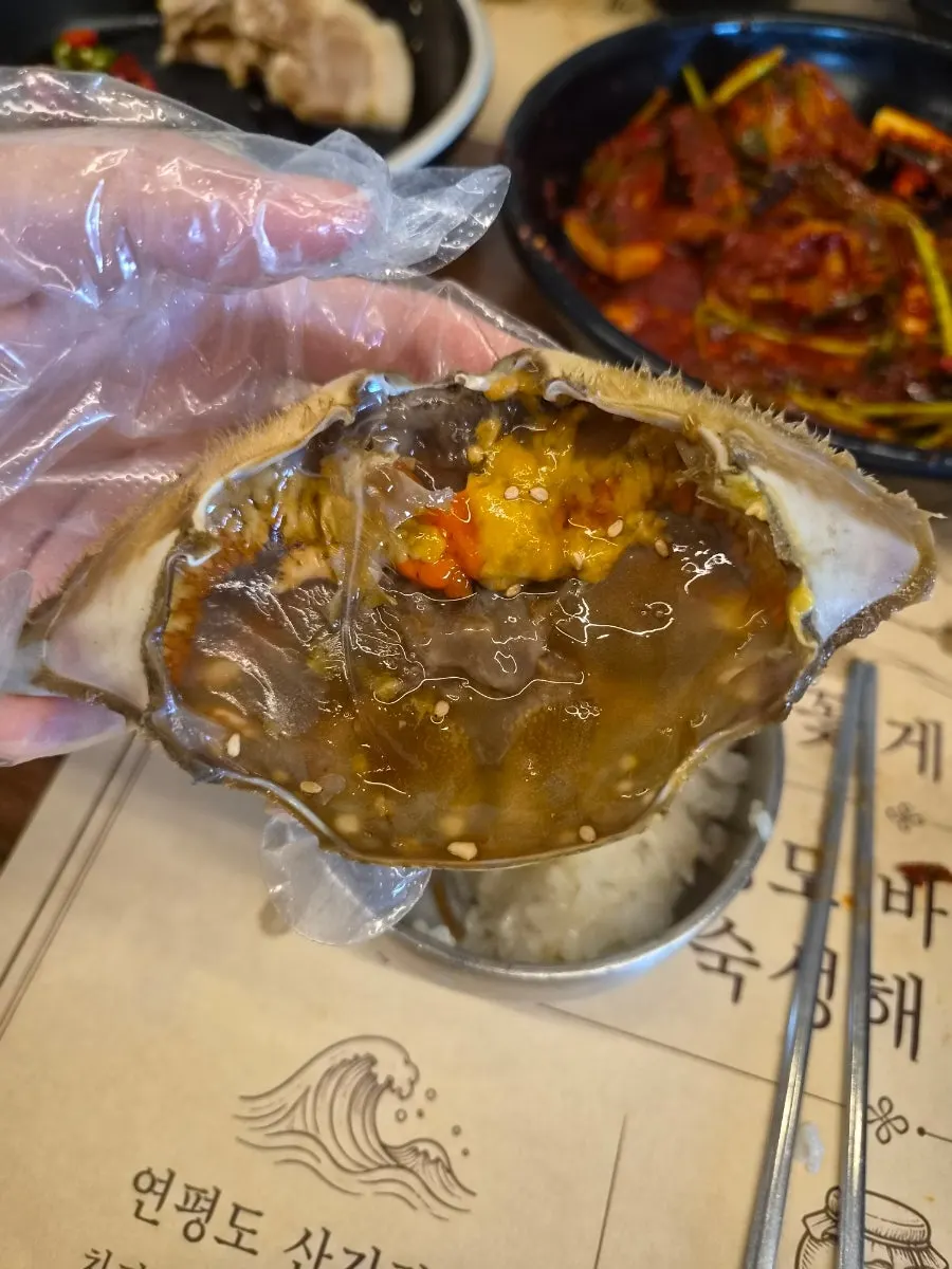 Rice and crab meat mixed inside the crab shell