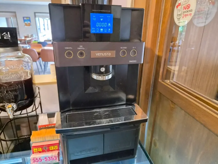 Self-serve pomegranate juice, plum tea, and coffee station near the exit