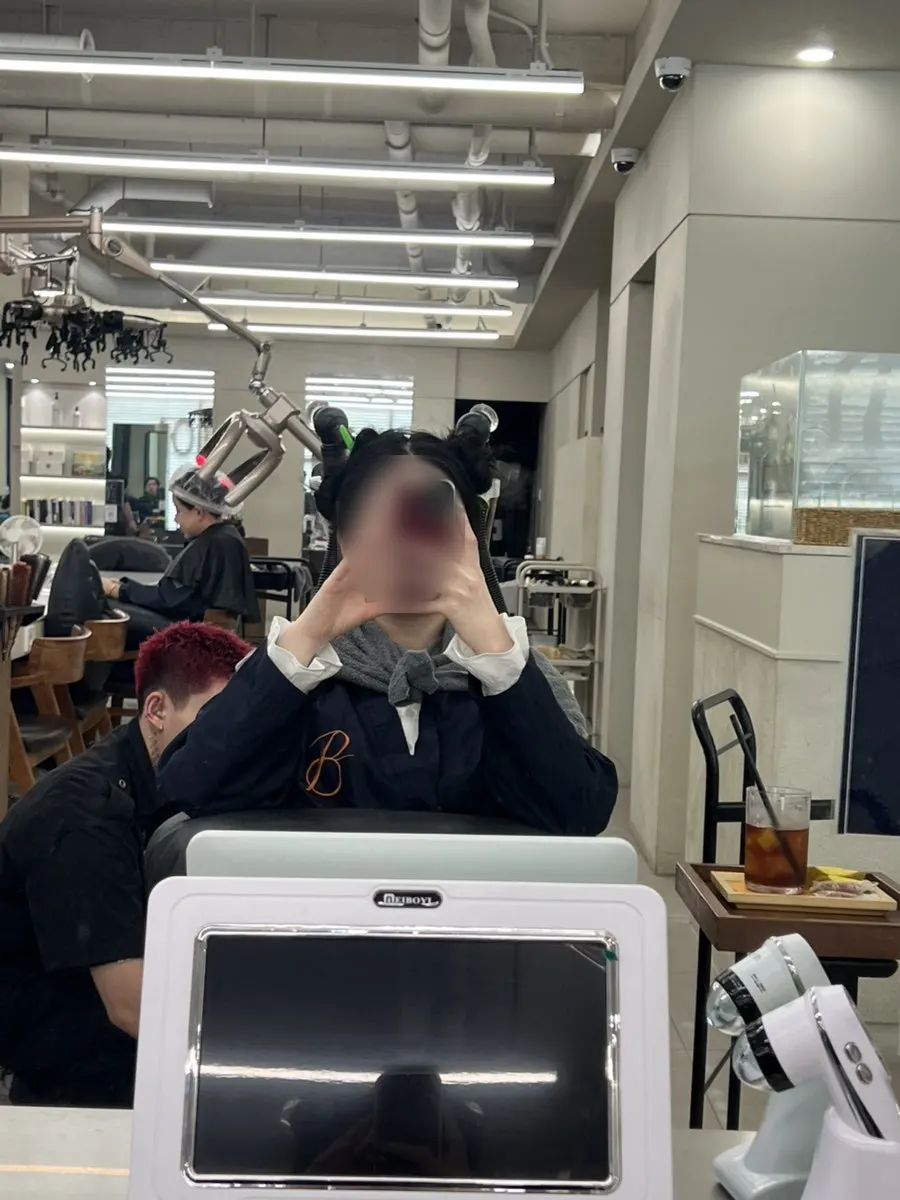 Hair tied up after tonic application, ready for scaling